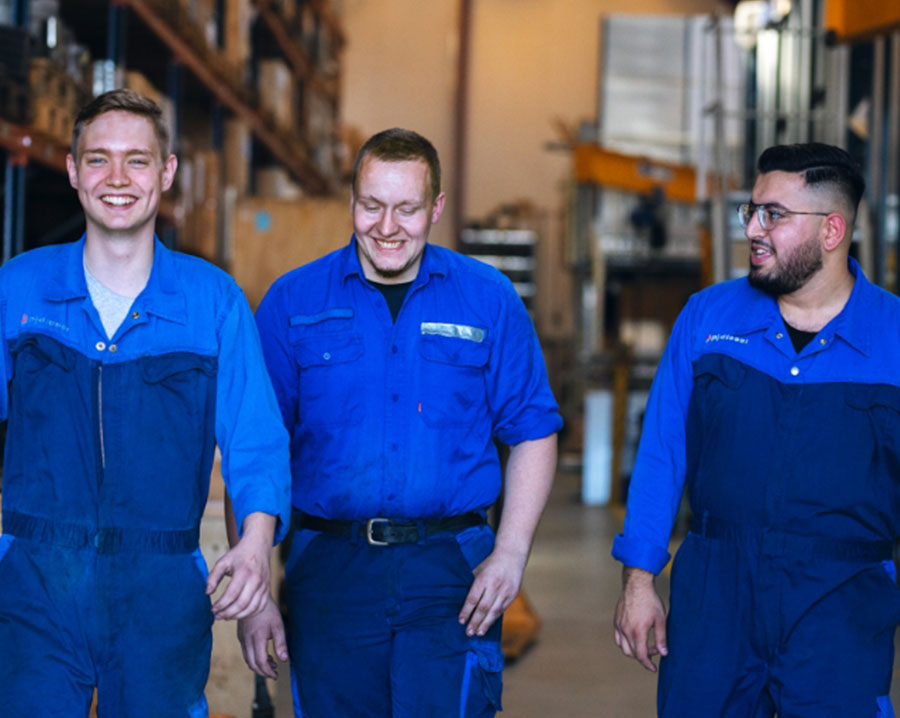 Three PJ Circular Engineering technicians walking through the workshop