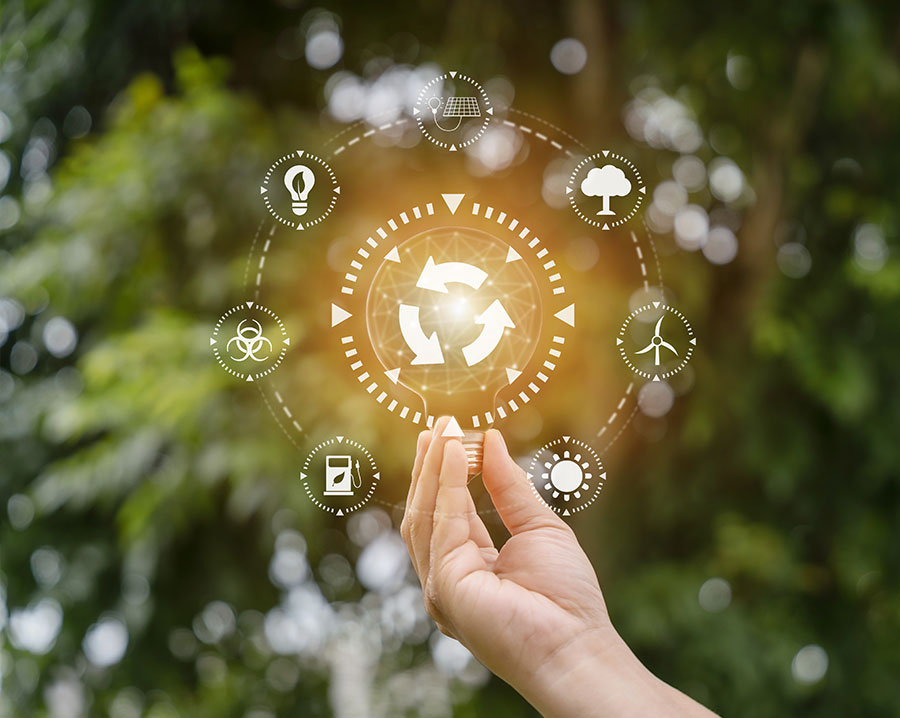 Hand holding a circular economy symbol surrounded by sustainability icons